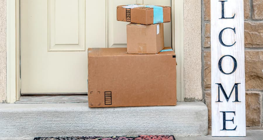 Deliveries on the front porch of a house with a welcome sign in New Brunswick